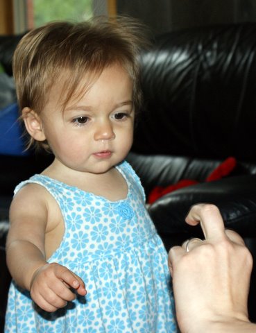 What is Mom doing with her finger?